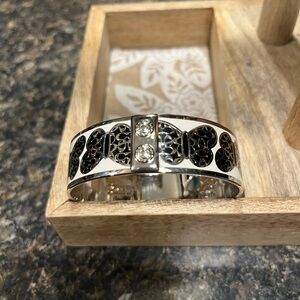 Coach Signature C Bangle Bracelet featuring black enamel Cs in Butterfly Cutouts